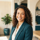 A smiling woman with healthy hair looking confident in a bright, modern studio setting.